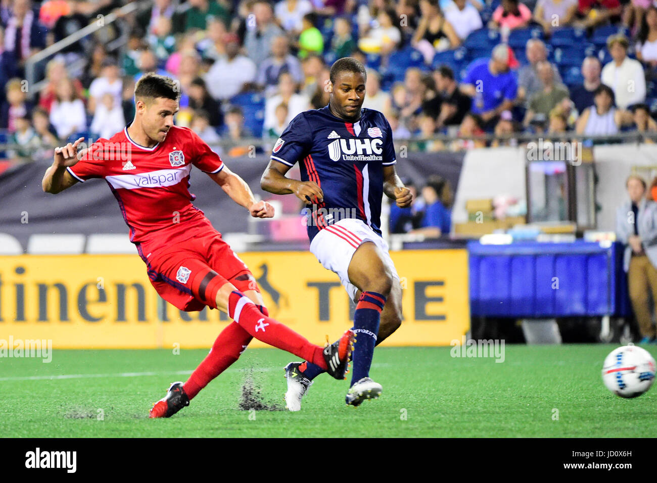 Foxborough Massachusetts, USA. 17th June, 2017. Chicago Fire forward Luis Solignac (9) gets his shot by New England Revolution defender Andrew Farrell (2) during the MLS game between Chicago Fire and the New England Revolution held at Gillette Stadium in Foxborough Massachusetts. Chicago defeats New England 2-1. Eric Canha/CSM/Alamy Live News Stock Photo