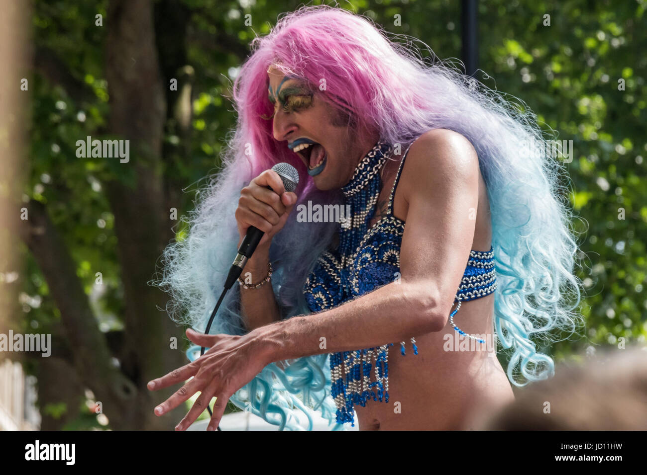 June 17, 2017 - London, UK - London, UK. 17th June, 2017. A gay cabaret performer in drag sings at the protest at Downing St calling on Theresa May to resign.THe DUP whose support she needs to get a majority are a party intrinsically linked with Protestant terrorist groups and dominated by a homophobic church which represents a tiny minority of the Northern Irish population, Northern Irish women campaigning for abortion and other women's rights, DPAC who spoke about the Tory assault on the disabled and others. Peter Marshall Images Live (Credit Image: © Peter Marshall/ImagesLive via ZUMA Wire Stock Photo