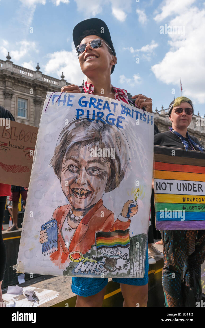 London, UK. 17th June, 2017. London, UK. 17th June, 2017. A man holds up a poster showing Theresa May holding lighter fluid and aligher in front of the NHS, Grenfell Tower and a rainbow flag with the title 'THe Great British PUrge' at the protest at Downing St calling on Theresa May to resign. Peter Marshall Images Live Credit: Peter Marshall/ImagesLive/ZUMA Wire/Alamy Live News Stock Photo