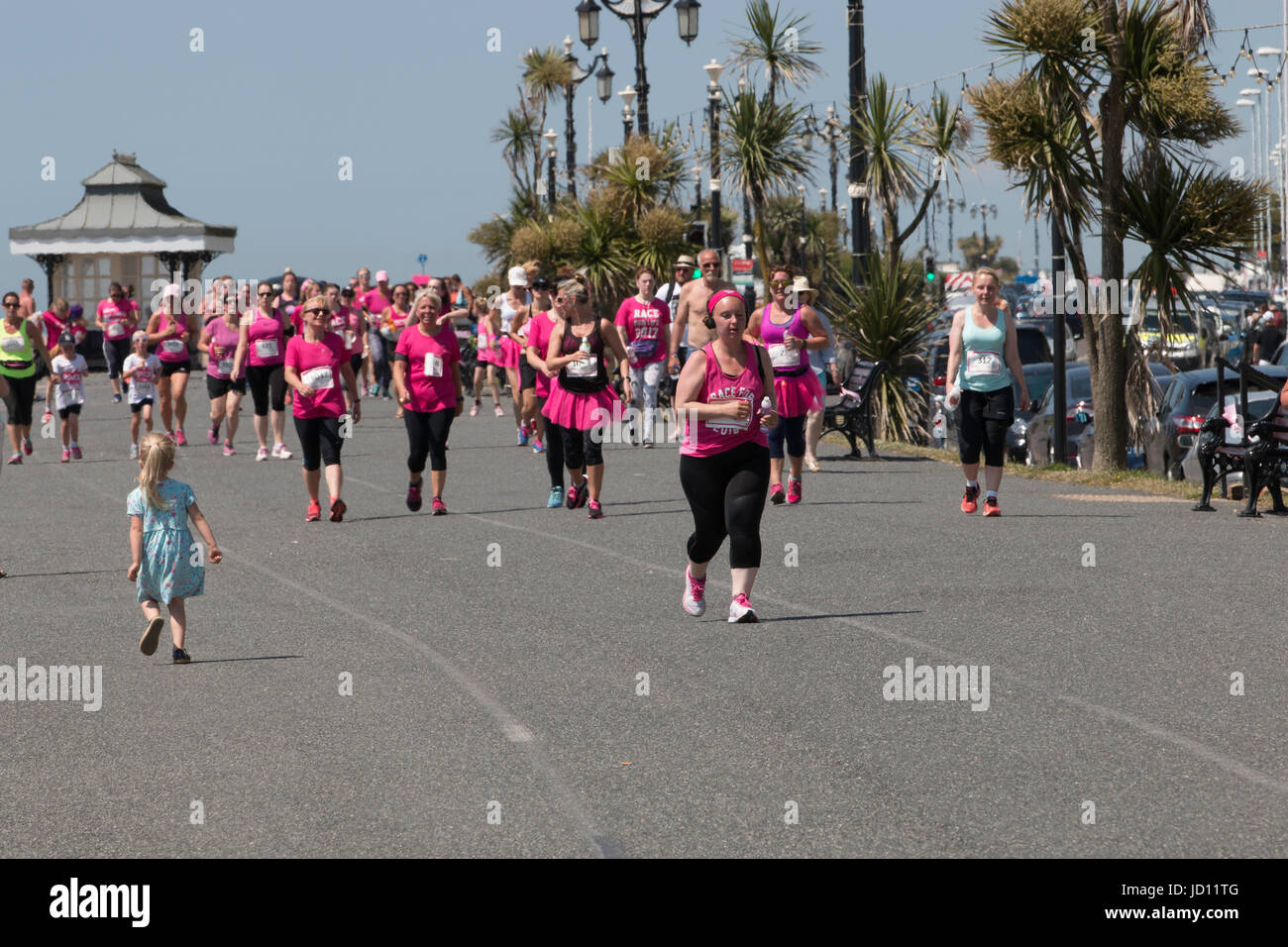 Worthing, UK, 18th June 2017, a small girl watches runners taking part in the 5K Race for Life, Credit Ian Stewart/Alamy Live News Stock Photo
