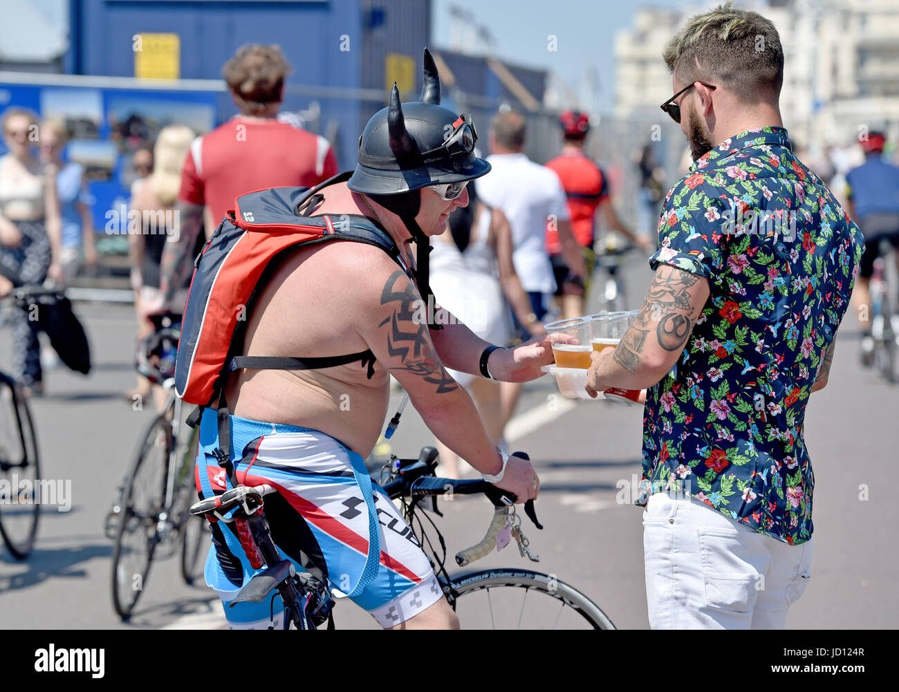 Brighton, UK. 18th June, 2017. This cyclist gets a beer after finishing the annual British Heart Foundation London to Brighton Bike Ride Credit: Simon Dack/Alamy Live News Stock Photo
