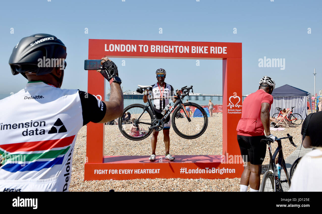 Brighton, UK. 18th June, 2017. Cyclists celebrate completing the annual British Heart Foundation London to Brighton Bike Ride in hot sunshine today Credit: Simon Dack/Alamy Live News Stock Photo