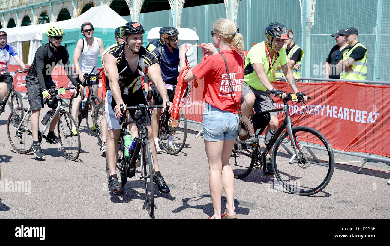 Brighton, UK. 18th June, 2017. Cyclists celebrate completing the annual British Heart Foundation London to Brighton Bike Ride in hot sunshine today Credit: Simon Dack/Alamy Live News Stock Photo