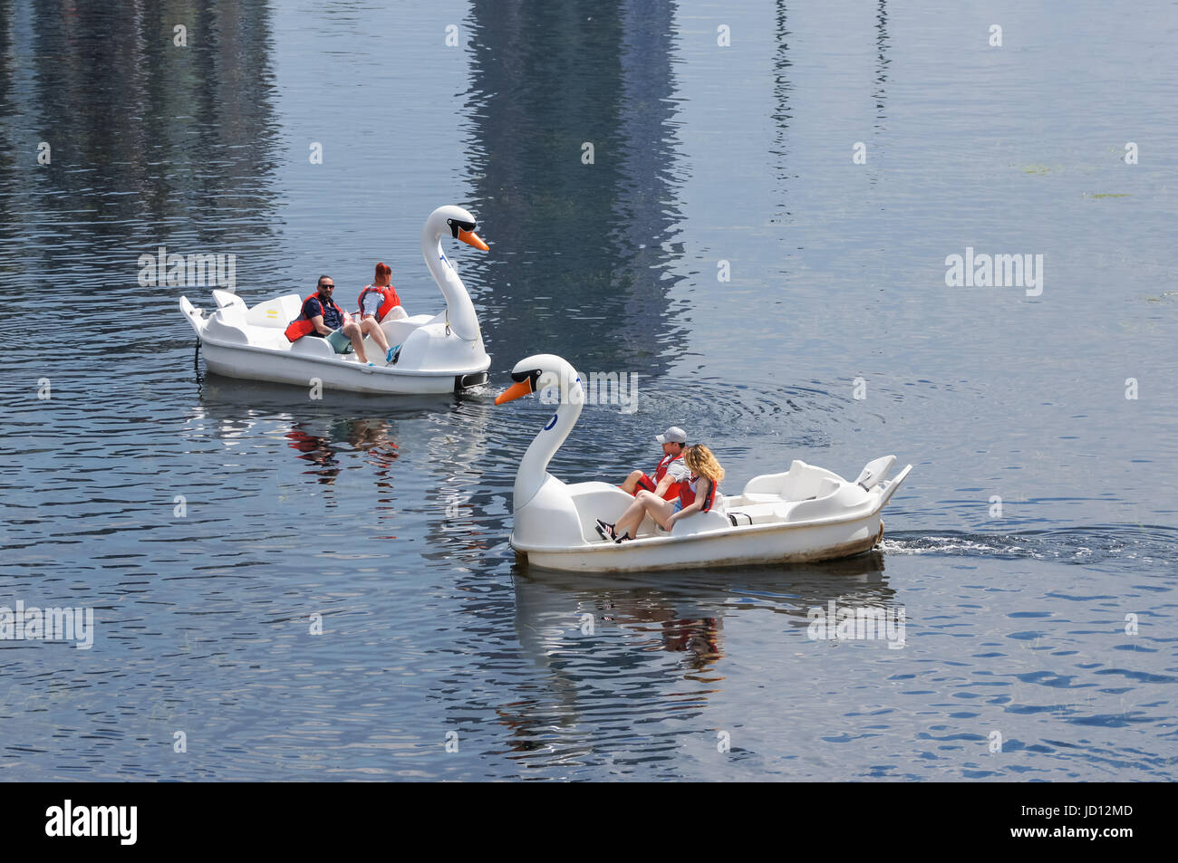 People enjoy hot day in swan pedalos on the river Lea at the Queen Elizabeth Olympic Park, London England United Kingdom UK Stock Photo