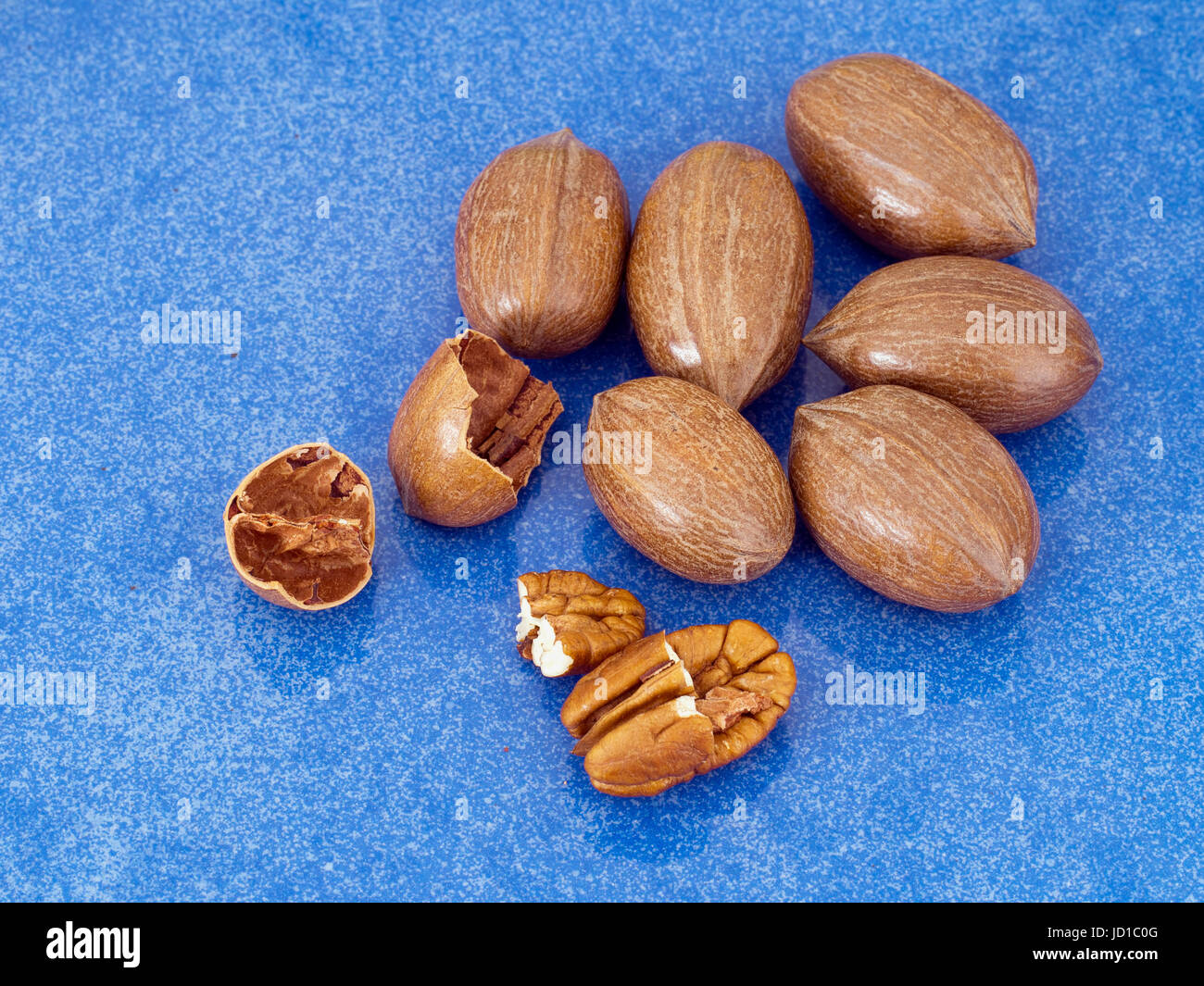 Pecan nuts on shiny blue background. Healthy snack, rich in vitamins, minerals Stock Photo Alamy