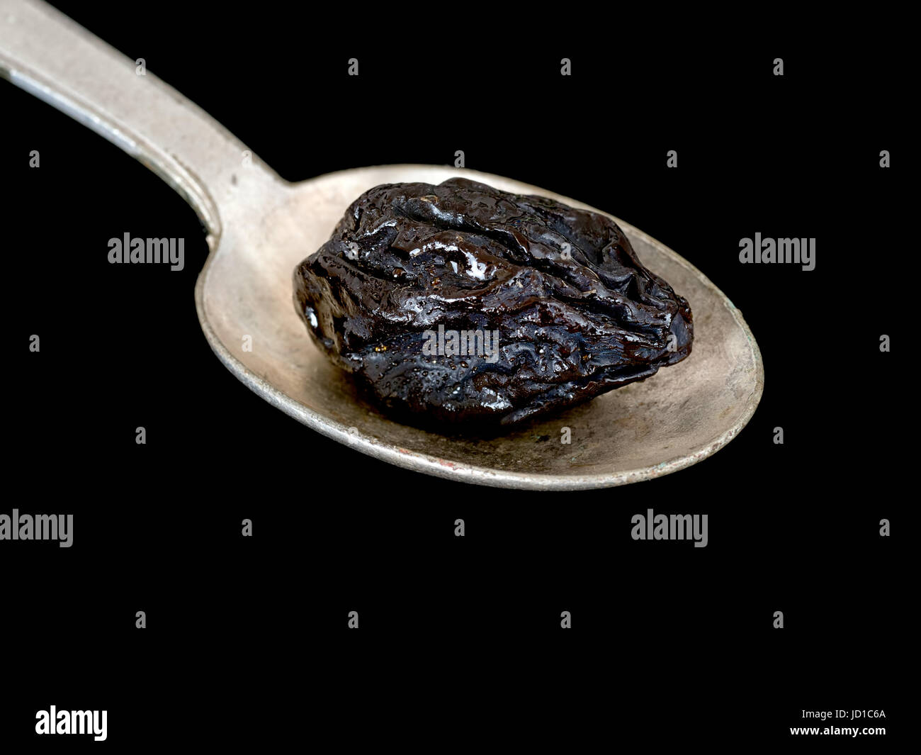 Prune on spoon. High in iron, boron and a traditional, natural remedy