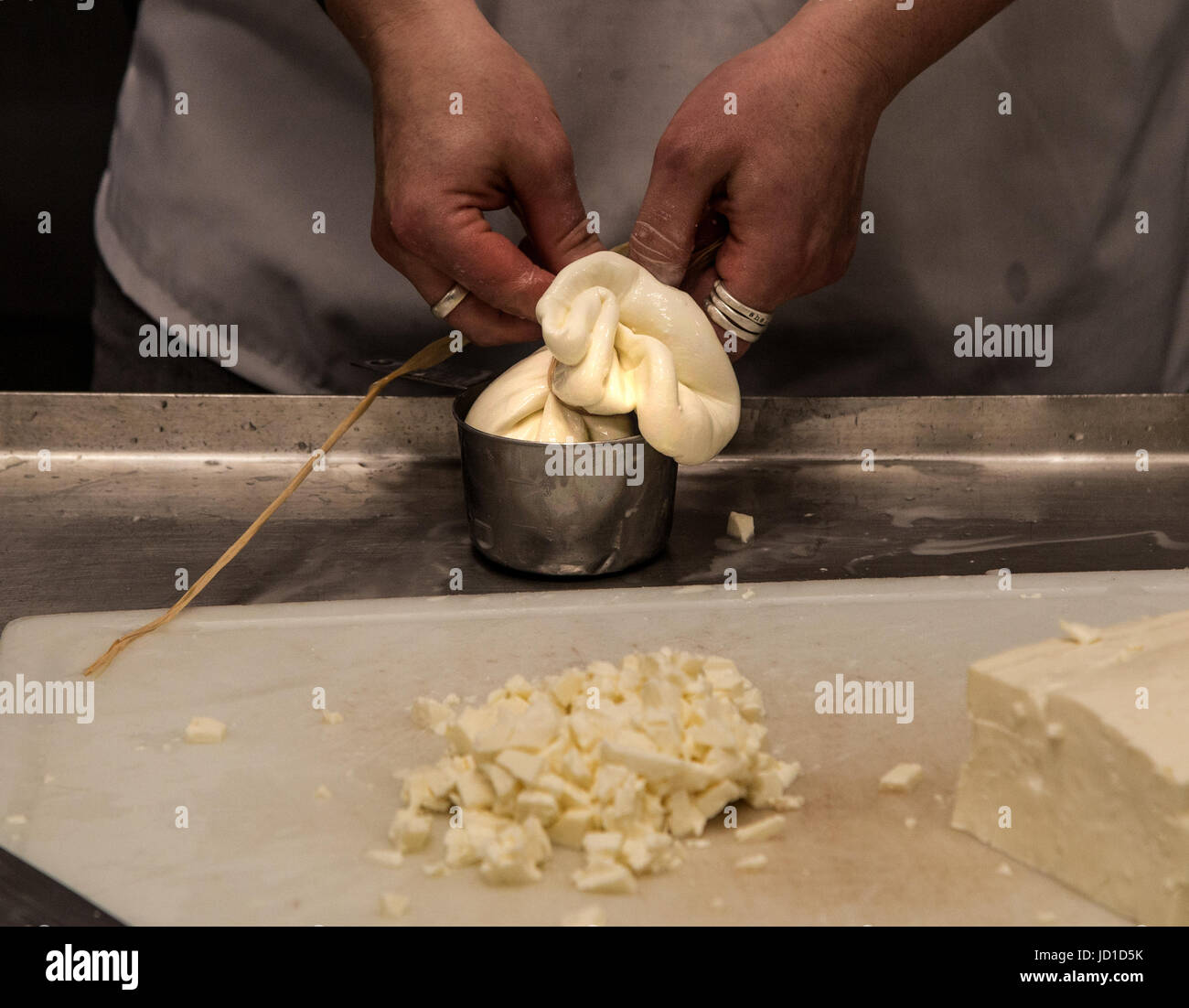 Making burrata mozzarella cheese with cream inside Stock Photo Alamy