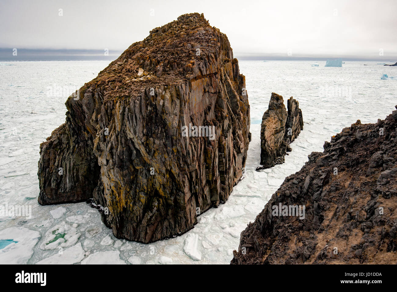 Rugged Coastline, Sea Stacks, and Sea Ice at Spillars Cove, near Bonavista, Cape Bonavista Peninsula, Newfoundland, Canada Stock Photo