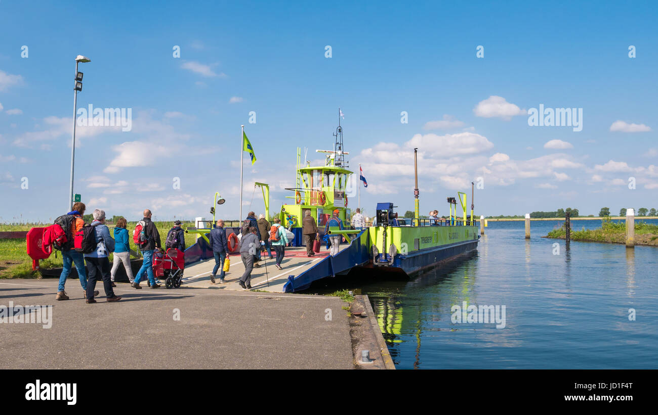 Passengers entering ferry boat leaving Tiengemeten island in Haringvliet estuary, South Holland, Netherlands Stock Photo