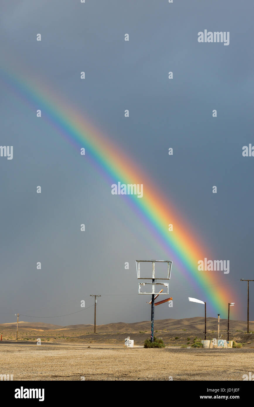 Rainbow over an abandoned gas station in Coaldale, Nevada. Stock Photo