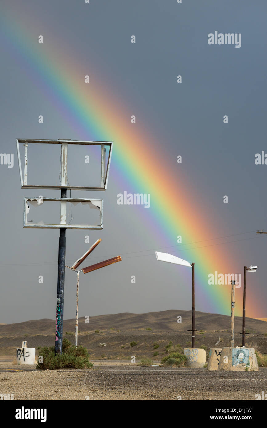 Rainbow over an abandoned gas station in Coaldale, Nevada. Stock Photo