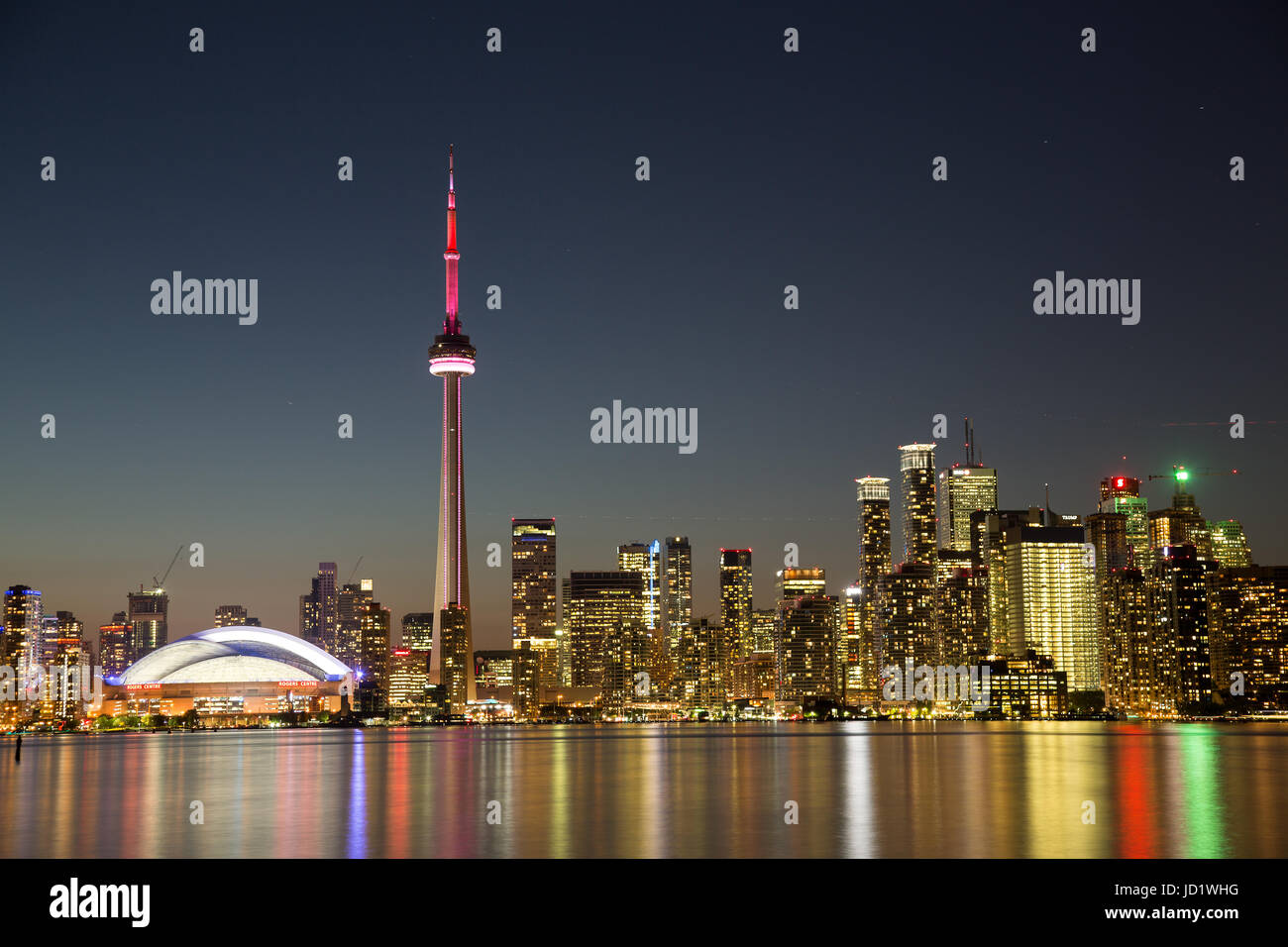 Toronto skyline at sunset with CN Tower and Rogers Centre Stock Photo ...