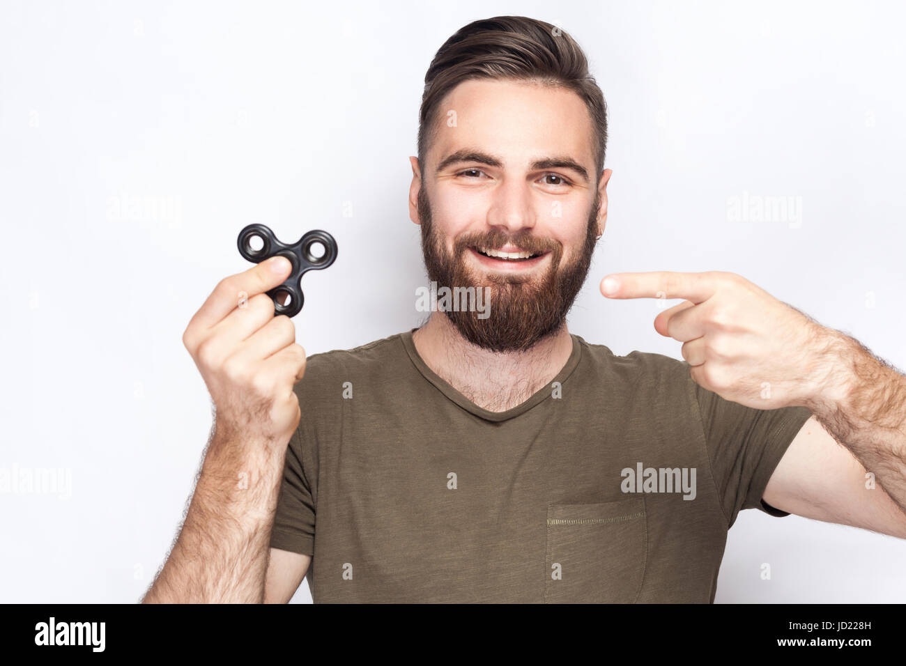 Young man holding and playing with fidget spinner. studio shot on white  background Stock Photo - Alamy