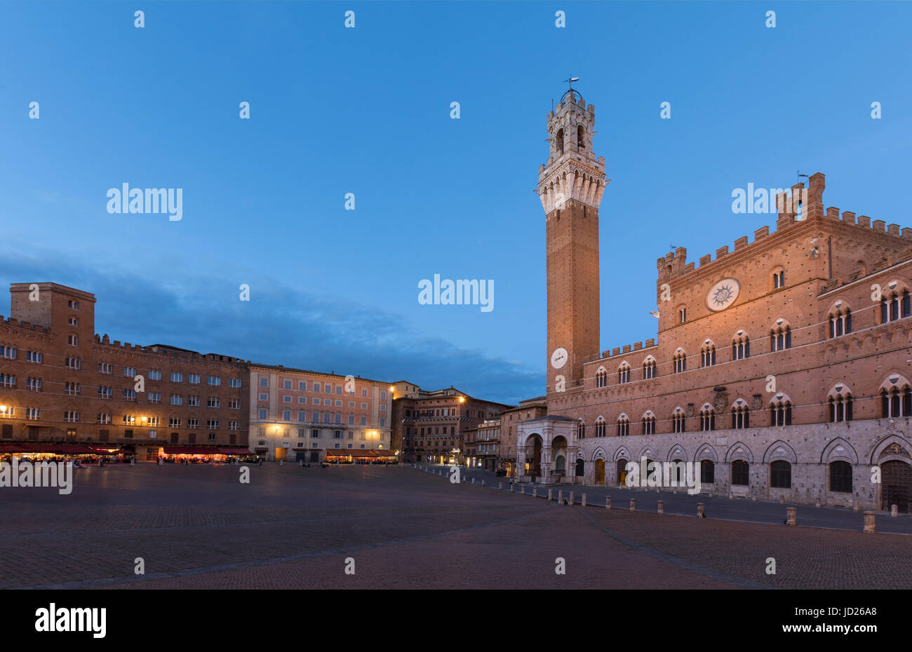 The Mangia Tower (Torre del Mangia) and Piazza del Campo at dusk - The city of Siena in Tuscany, Italy. The historic centre of Siena is a UNESCO a Wor Stock Photo