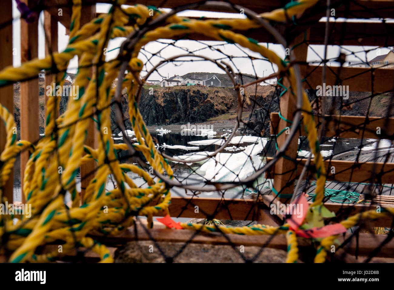 View through wooden lobster trap on dock in Crow Head, Twillingate, Newfoundland, Canada Stock Photo