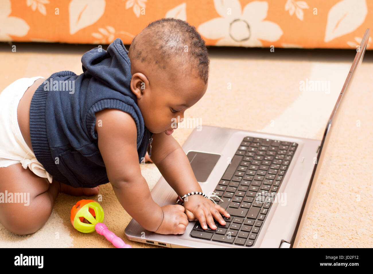 baby playing  with the laptop in the house Stock Photo