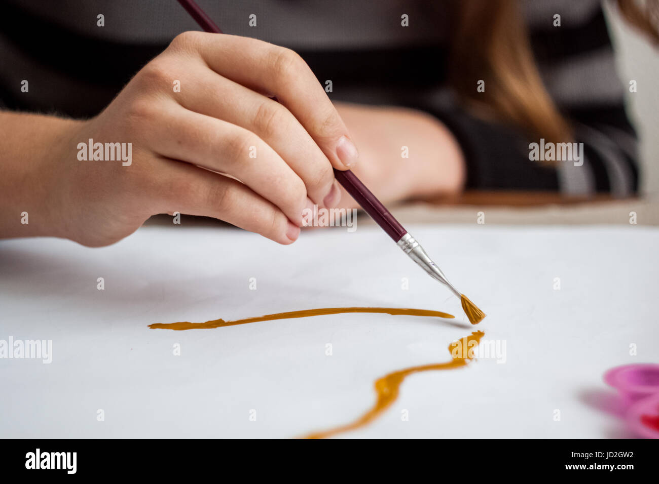 Girl painting with brush and colorful paint Stock Photo - Alamy