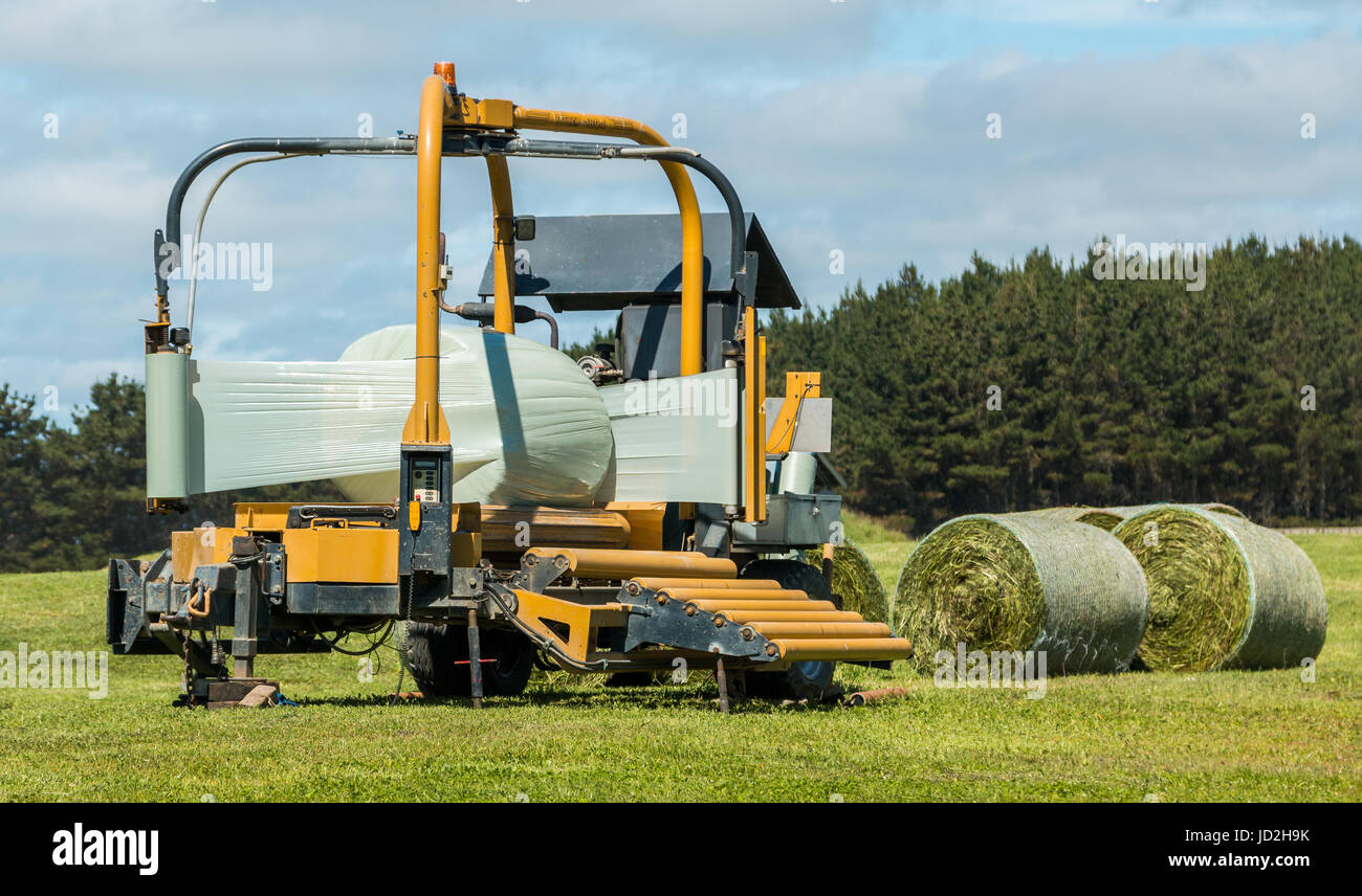 Round Baler wrapper wrapping up a bale Stock Photo Alamy