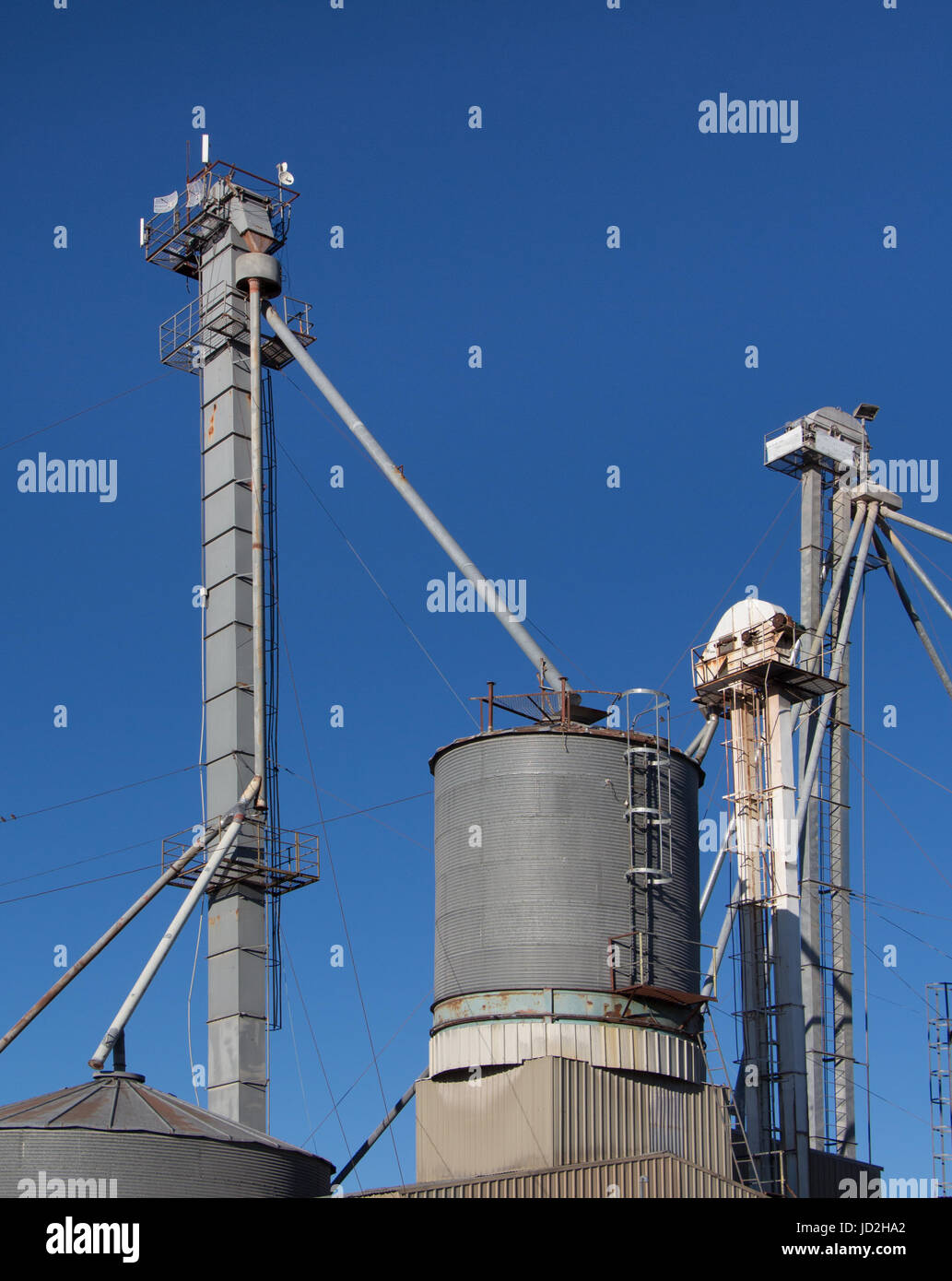 Tall grain silo's feed pumps Stock Photo Alamy