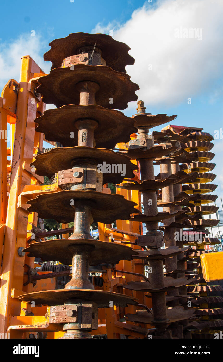 Steel disks on a farming machine used to break up the soil after plowing. Stock Photo