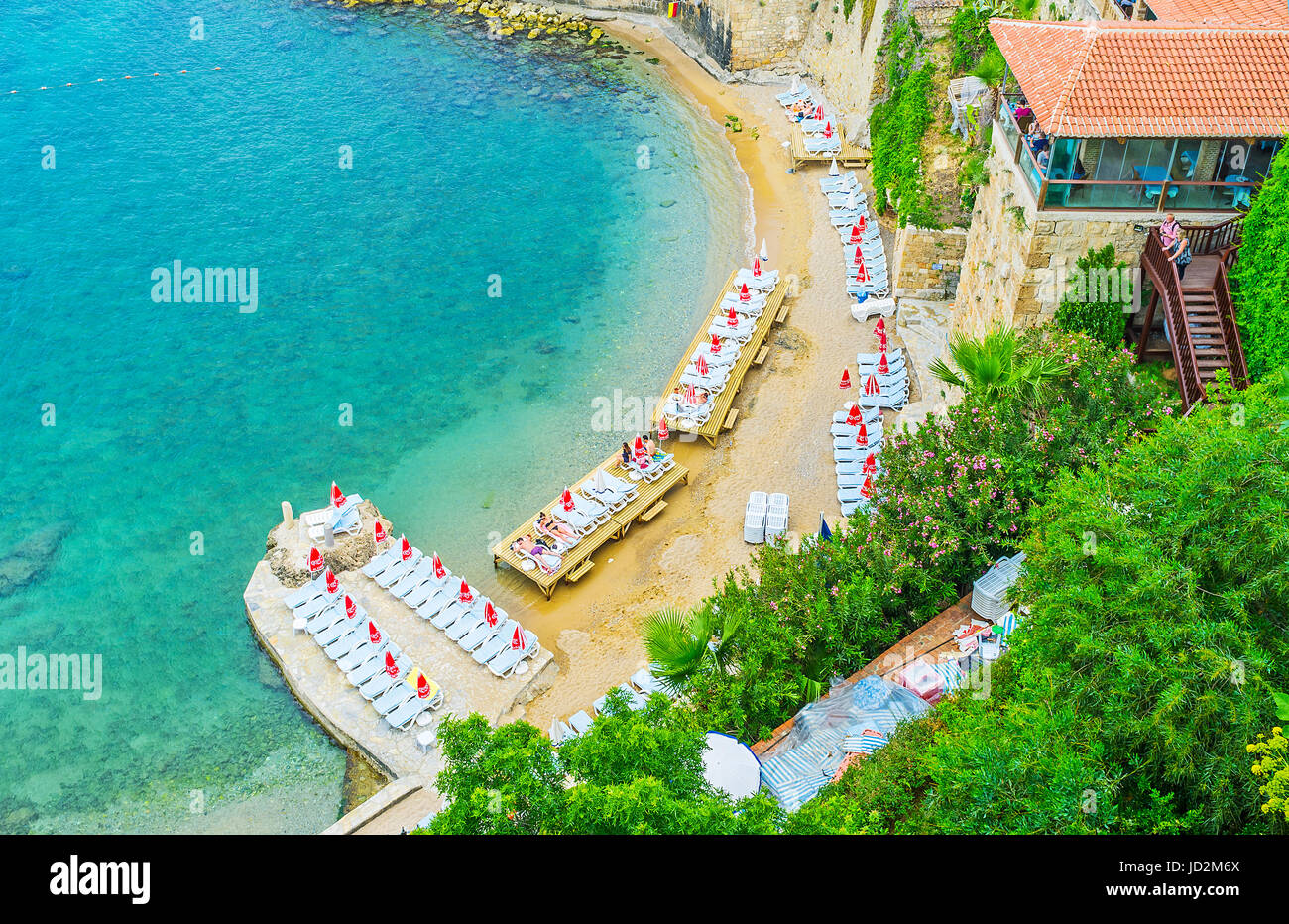 ANTALYA, TURKEY - MAY 6, 2017: Aerial view of Mermerli beach with the sun beds, stairs to the luxury restaurant, lush garden on the slope and crystal  Stock Photo