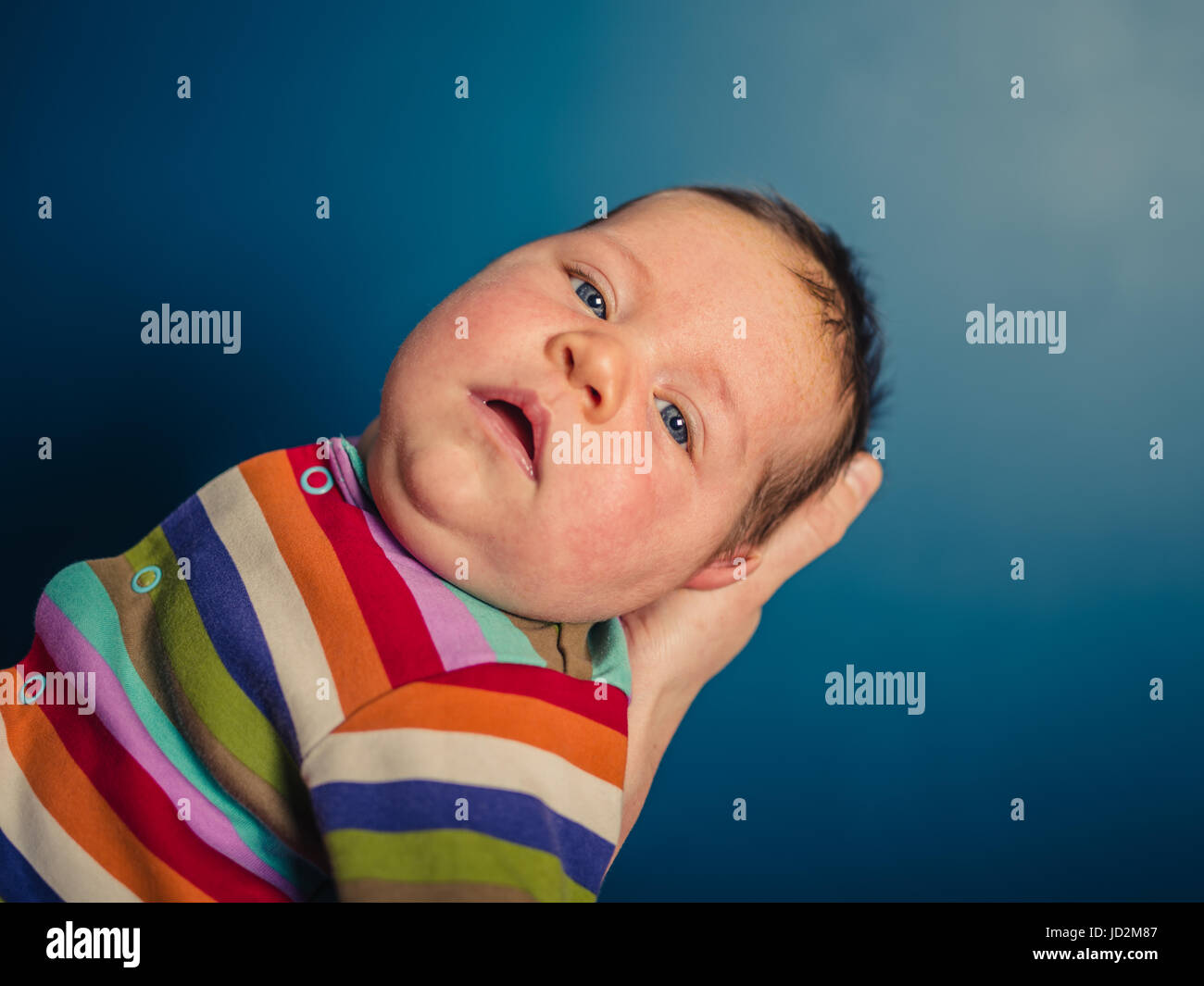 A pretty baby boy in a rainbow romper Stock Photo Alamy