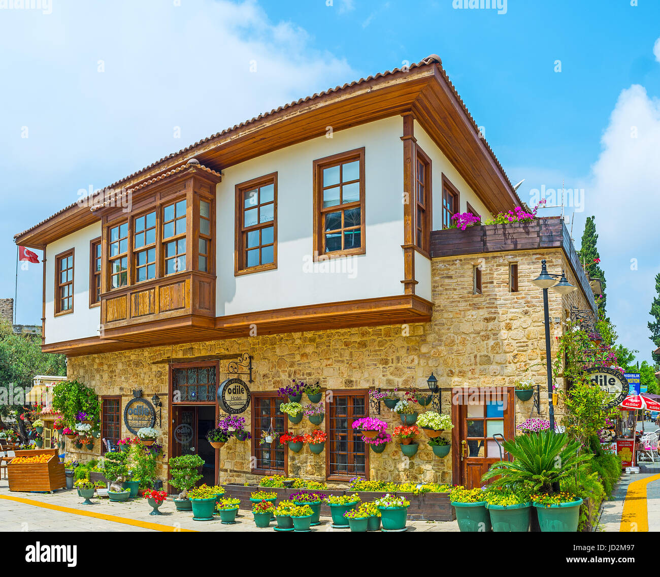 ANTALYA, TURKEY - MAY 6, 2017: The traditional hotel in Ottoman townhouse decorated with colorful pansies and petunias in pots, on May 6 in Antalya. Stock Photo