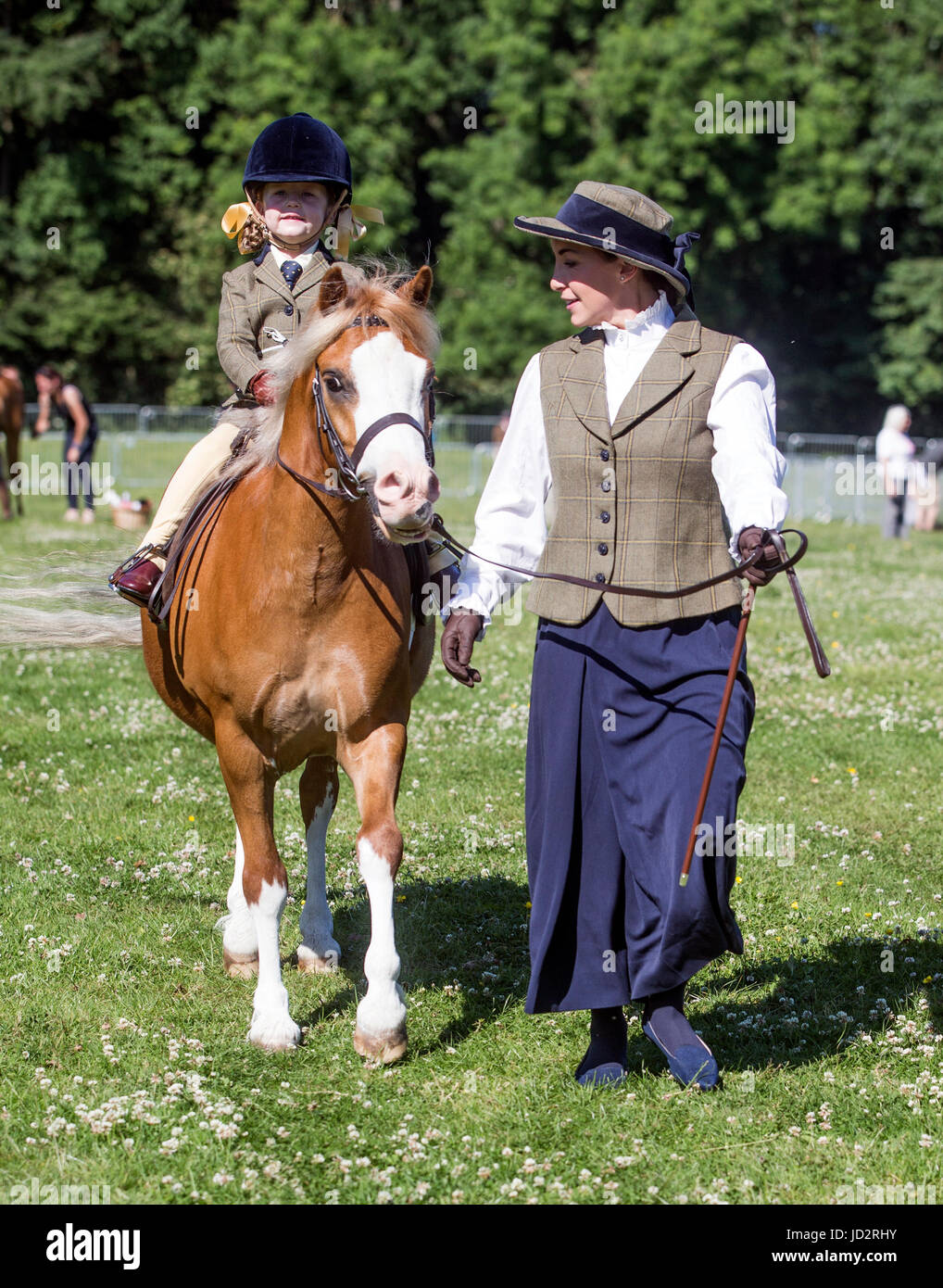 Rebecca Adams with her daughter Fenella Adams riding Dukes Hill Dancing Digger ahead of competing in the M&M Lead Rein during the 39th North Yorkshire County Show on the Camp Hill Estate in Yorkshire. Stock Photo