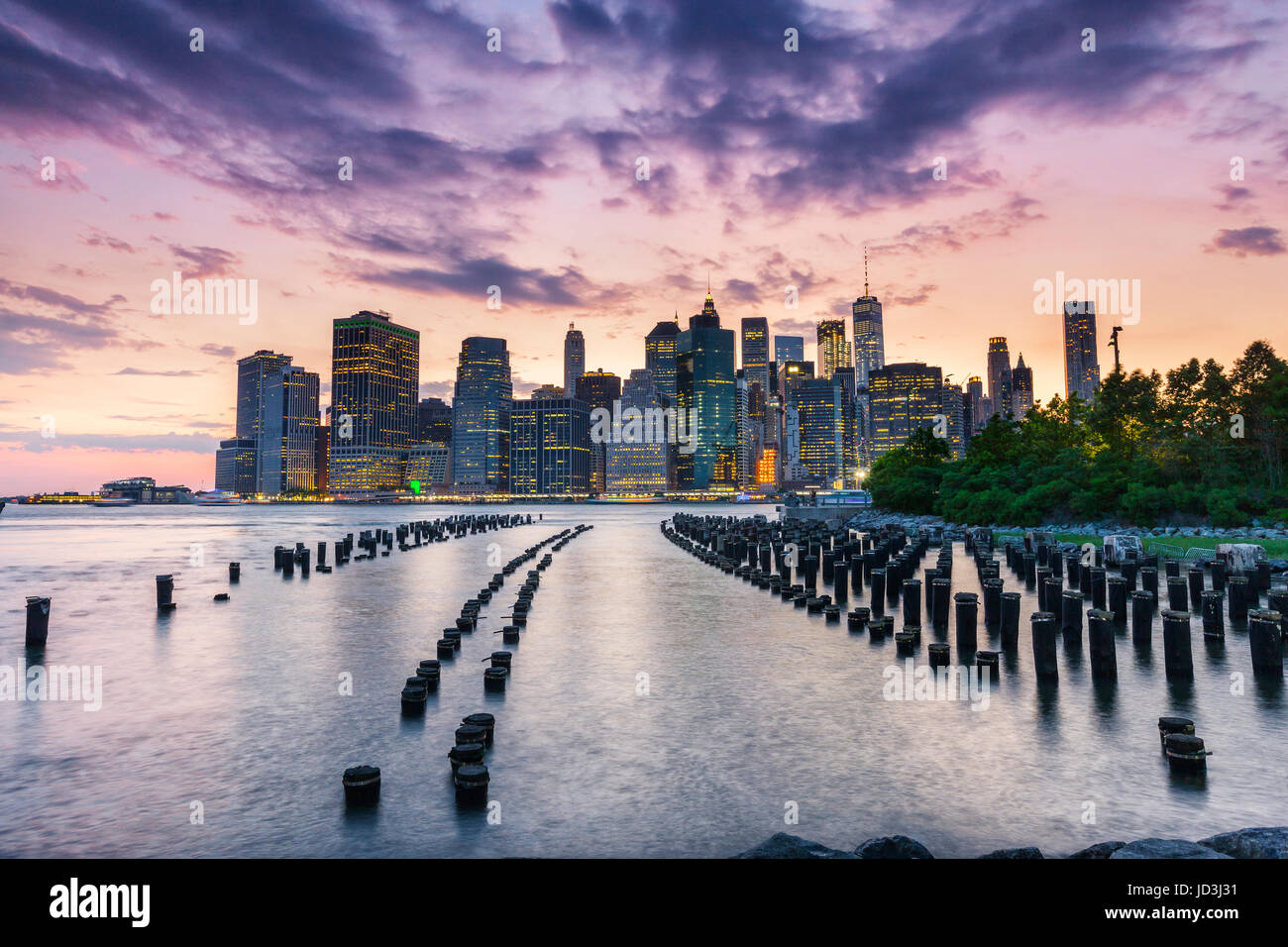 New York City, wood pilings and Manhattan at sunset Stock Photo