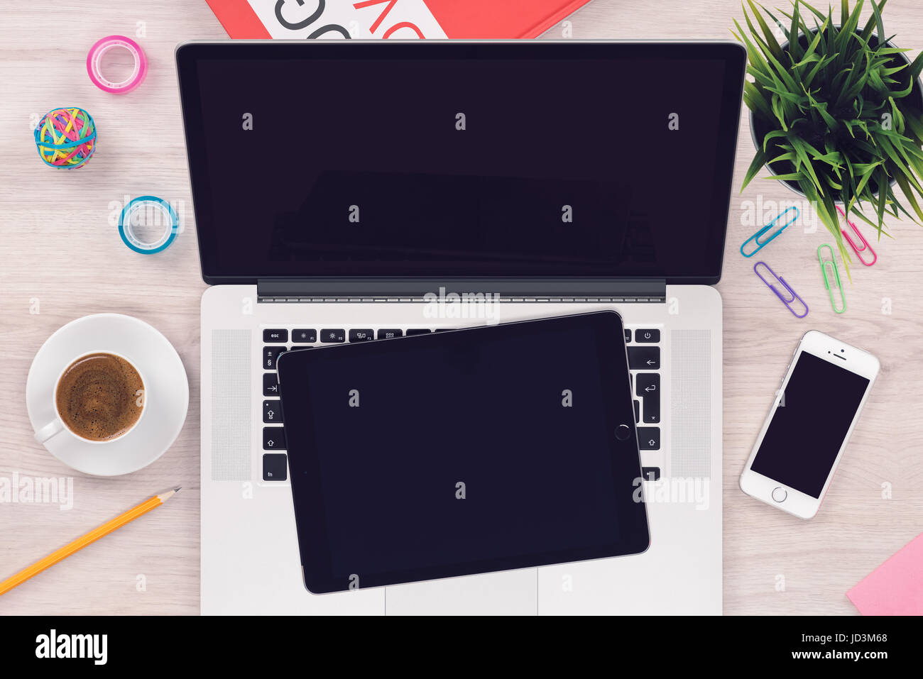 Top view flat lay workspace mockup with open laptop tablet pc and smartphone on office wooden desk Stock Photo