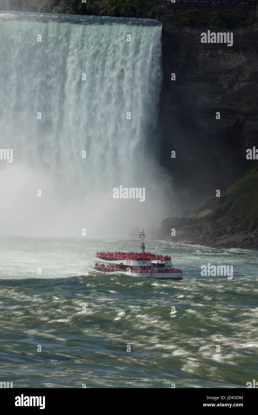 Tour boat, 'Maid of the Mist', at Niagara falls, Horseshoe falls Canada in backgroung, American falls in foreground Stock Photo