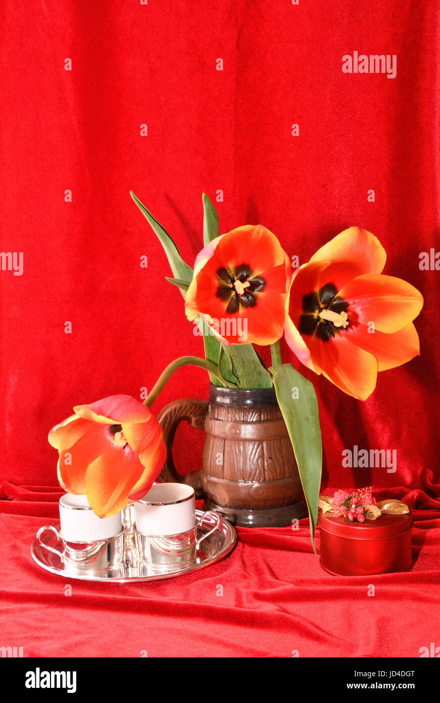 Still life with tulips on a red background Stock Photo - Alamy