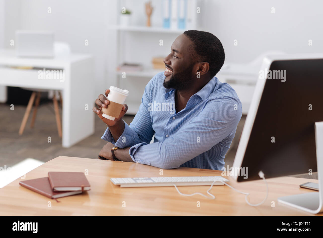 Happy positive man holding a cup of coffee Stock Photo