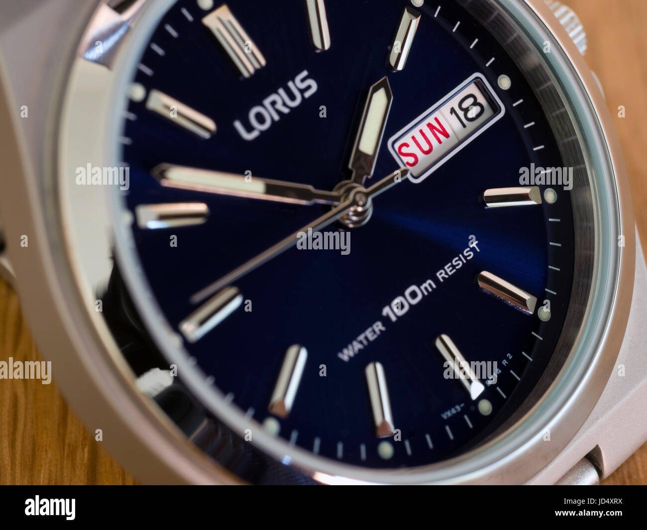 Men's Lorus analogue wristwatch, watch with deep blue face, day and date display and stainless steel case. Stock Photo