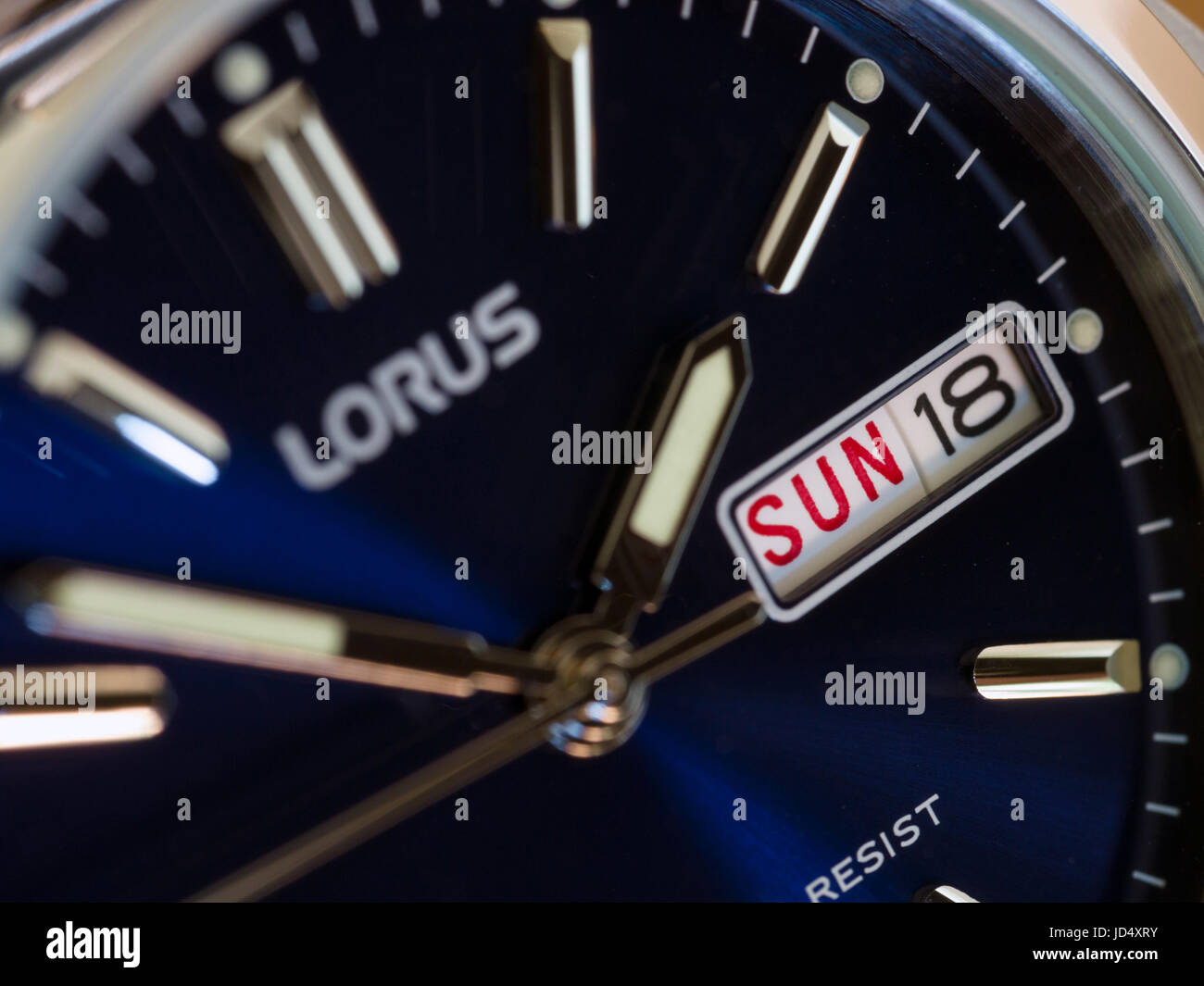 Men's Lorus analogue wristwatch, watch with deep blue face, day and date display and stainless steel case. Stock Photo