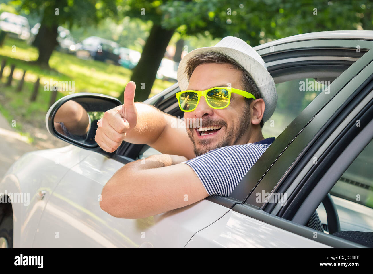 Man wearing sunglasses driving car hi-res stock photography and