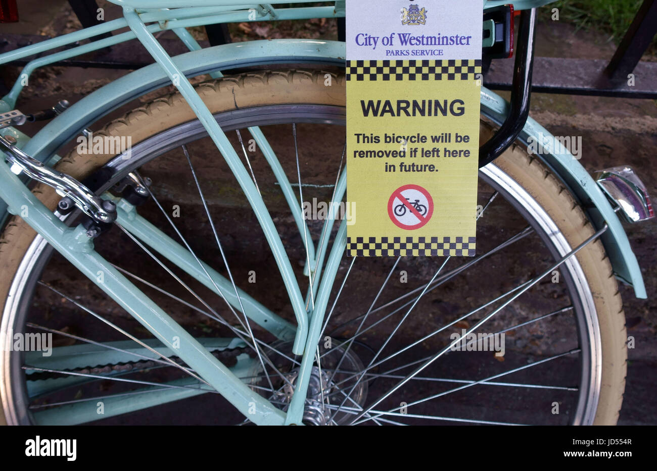 Council warning notice on bicycle about removal Stock Photo