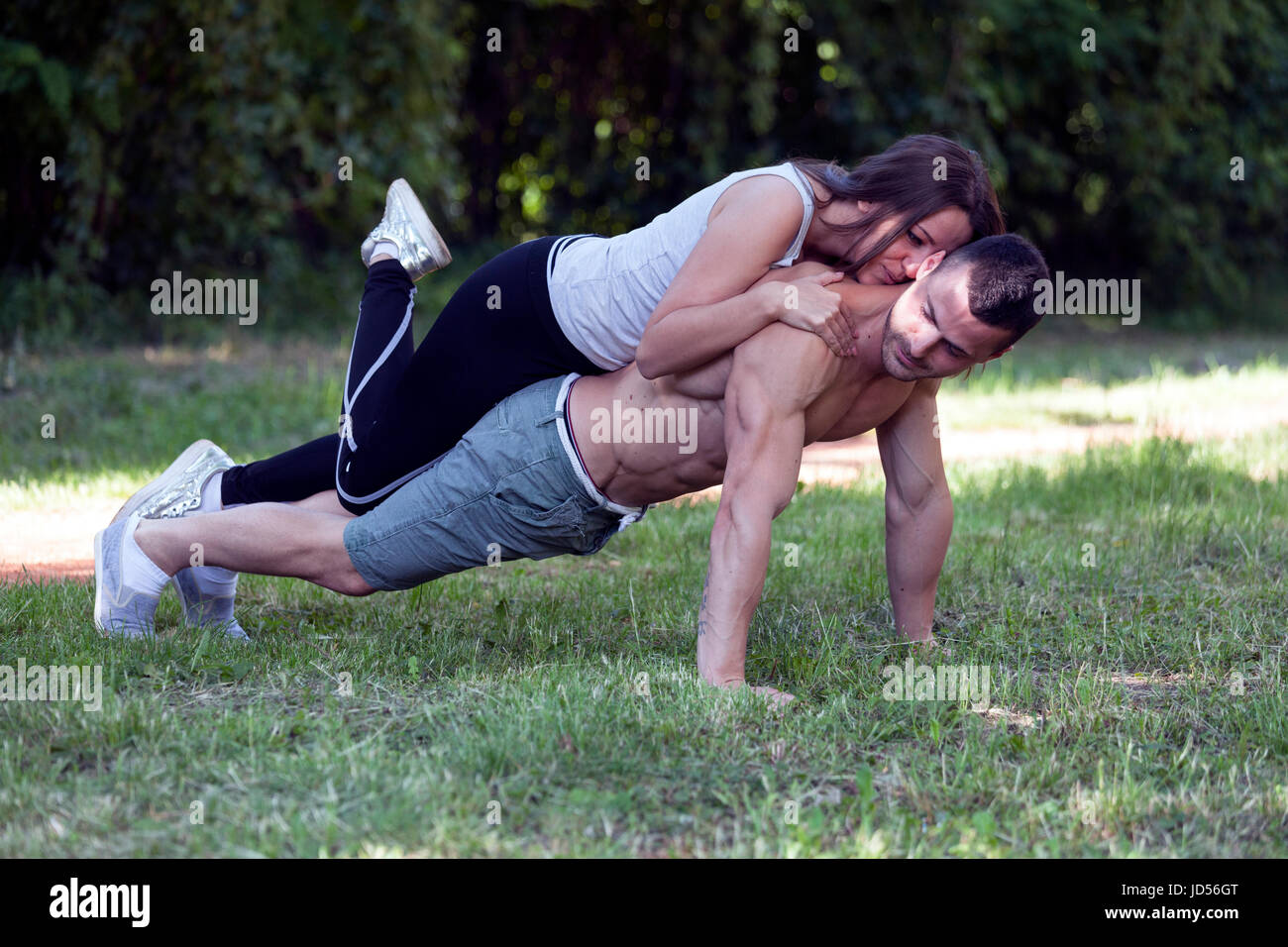Young loving couple, man and woman enjoy while exercising together in ...