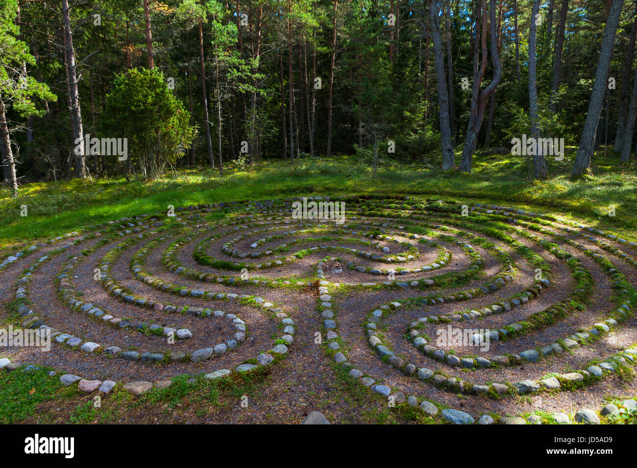 Mystic oriental stone labyrinth in green forest, aestetic symbol Stock Photo