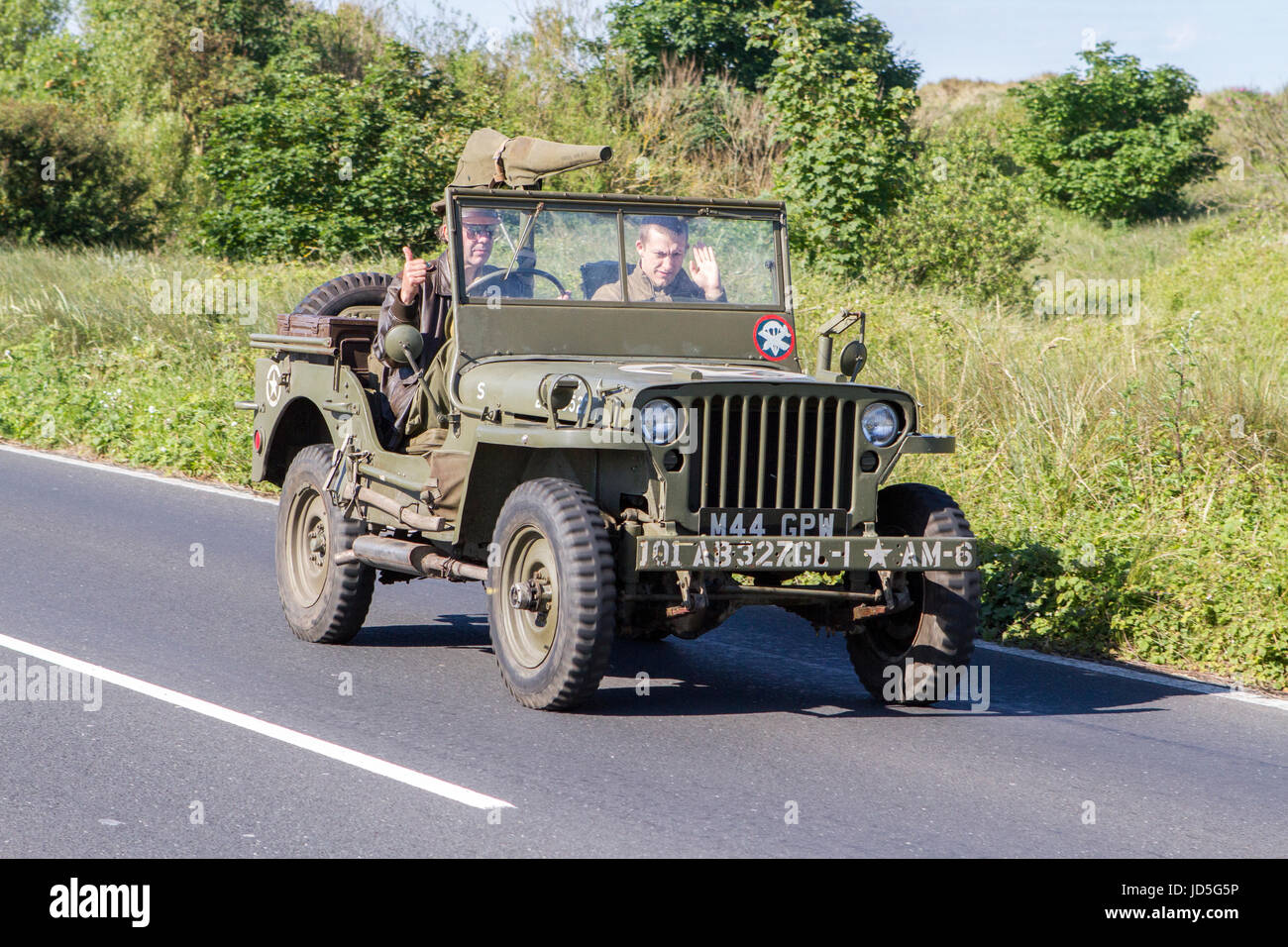 A Mahindra army military jeep travels along the coast road to attend the Southport motorfest in Merseyside. Stock Photo
