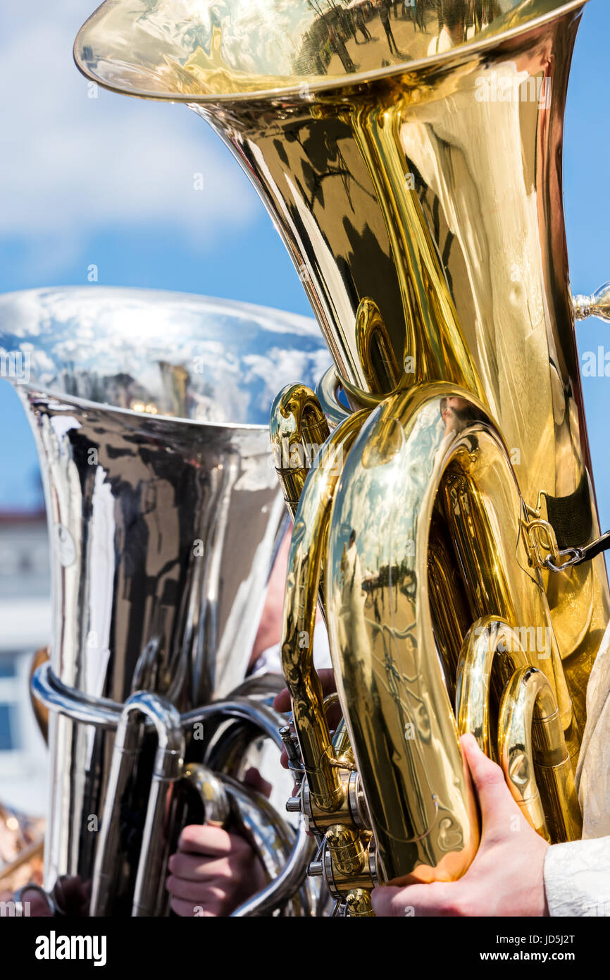 bright big brass bass tubas against blue sky background Stock Photo