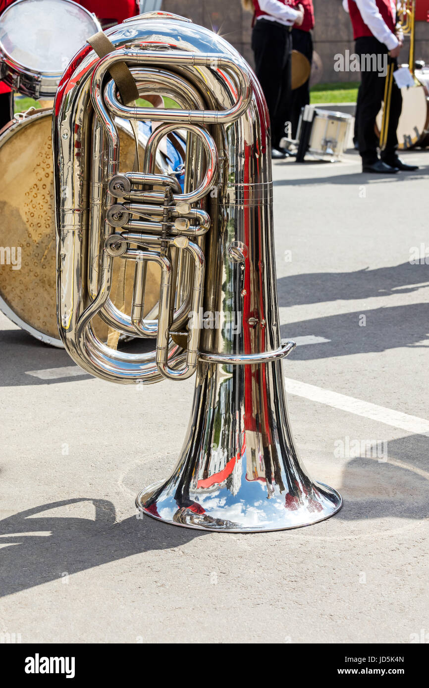 music instruments closeup. bright big bass tuba on pavement background during the break of orchestra performance. Stock Photo