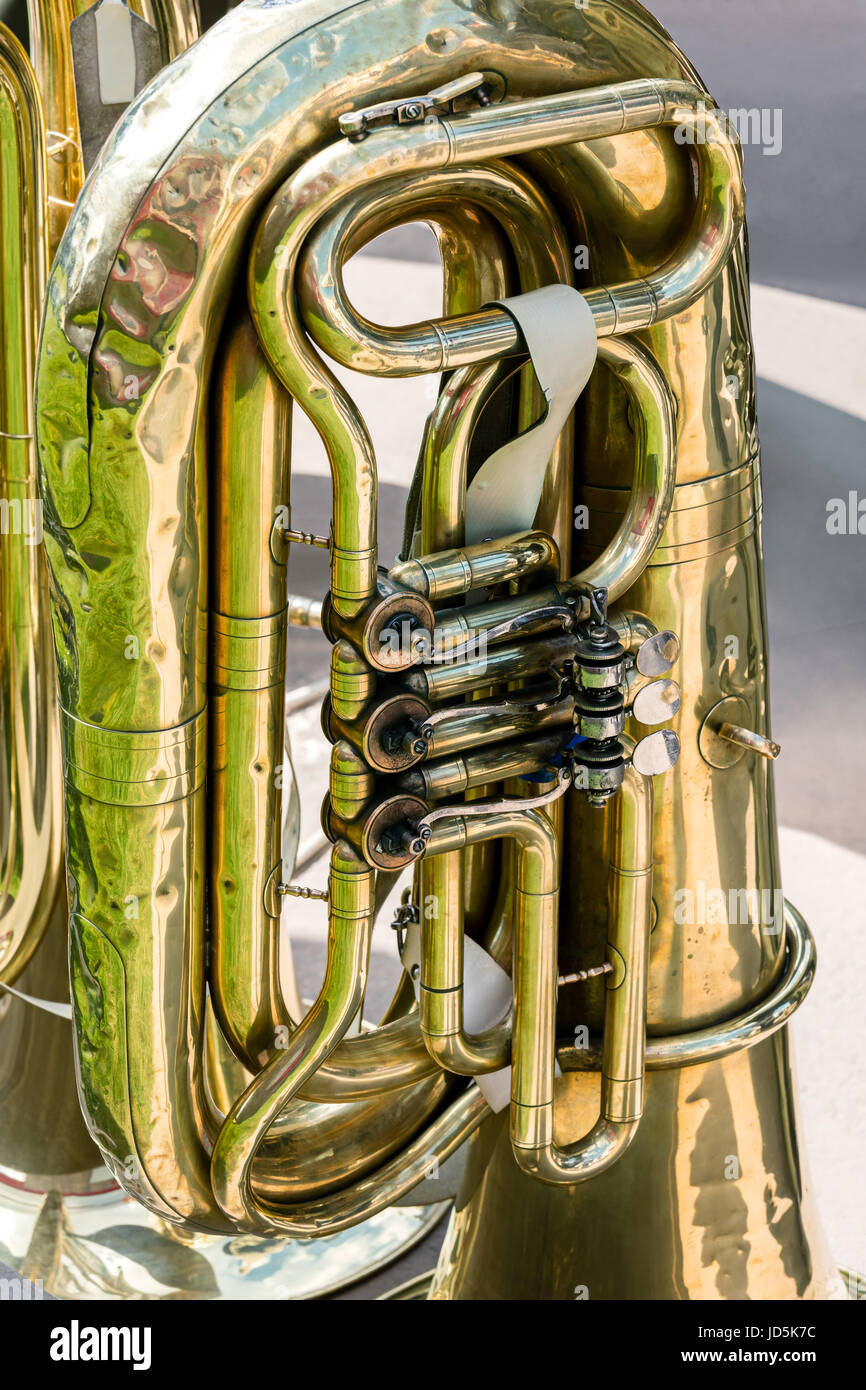 old brass tuba mechanism. worn valves bass tuba closeup. Stock Photo