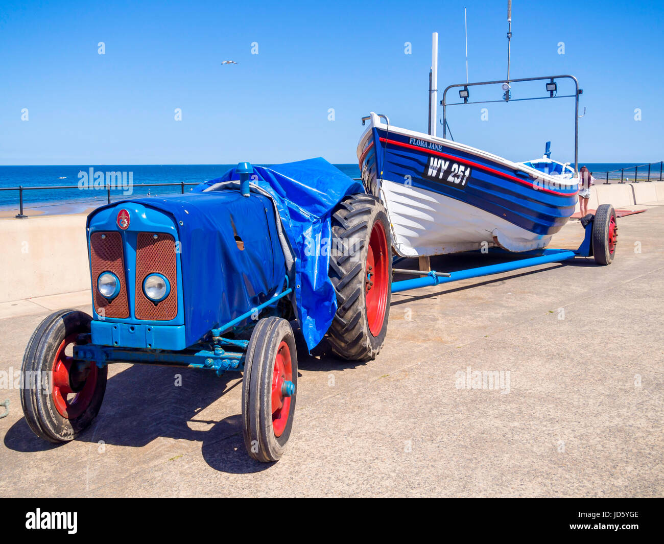Smartly painted fishing boat FLORA JANE and tractor parked the Esplanade at Redcar North Yorkshire UK Stock Photo
