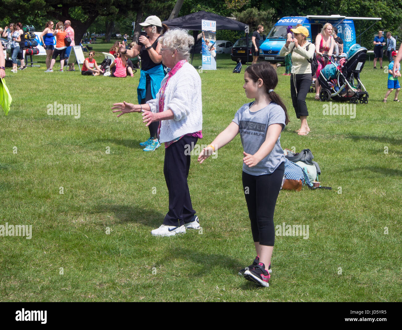 People taking part in a mixed age and ability exercise class outdoors Stock Photo