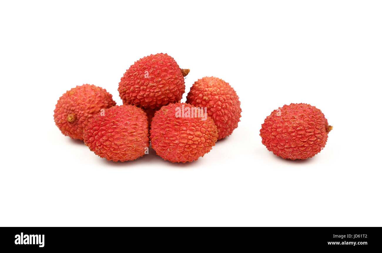 Group of fresh red ripe litchee (Litchi chinensis) tropical fruits isolated on white background, detail close up in different perspectives, low angle  Stock Photo