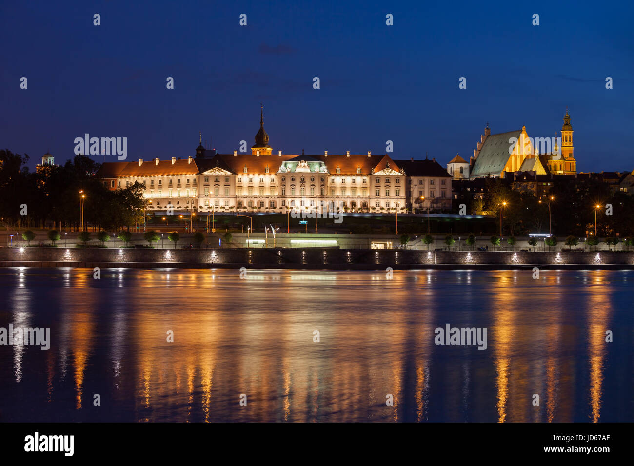 Royal Castle in city of Warsaw, Poland illuminated at night, historic city landmark, view across Vistula River, Baroque and Mannerist architecture Stock Photo