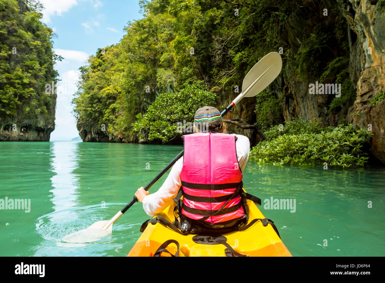 Woman on kayak in calm tropical lagoon on Koh Hong island Stock Photo