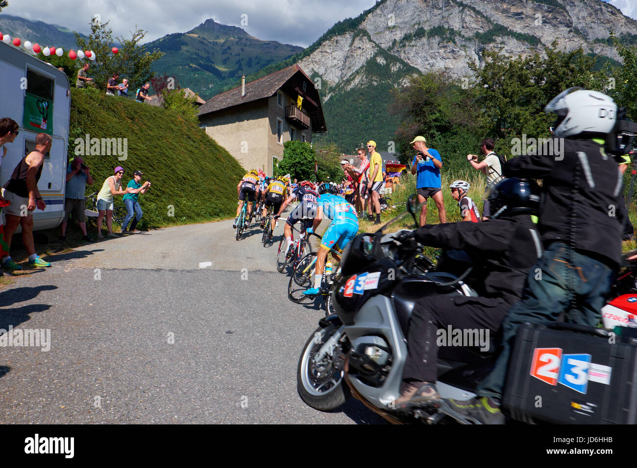 MONTVERNIER, FRANCE - JULY 23, 2015: Camera crew on motorcycle, behind bicycle riders who are climbing a mountain in the Tour de France Stock Photo
