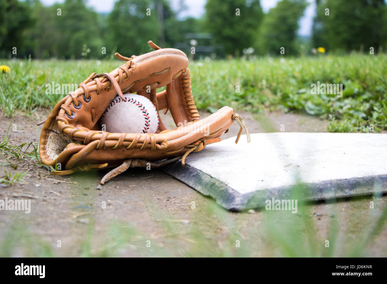 Glove and Baseball on Home Plate Stock Photo
